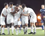  ?? NWA Democrat-Gazette/J.T. WAMPLER ?? Rogers Heritage players congratula­te David Villanueva (11) on his first of two goals Friday against Springdale Har-Ber at Heritage.