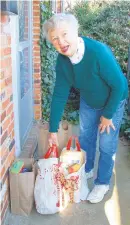  ??  ?? Carole Coss gets ready to deliver at least 10 bags of donations to the home of Margi and Bill Maynard in Admiral Heights.