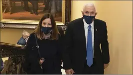  ?? HOUSE SELECT COMMITTEE VIA AP, FILE ?? Vice President Mike Pence and his wife, Karen, walk at the Capitol in Washington on Jan 6, 2021.