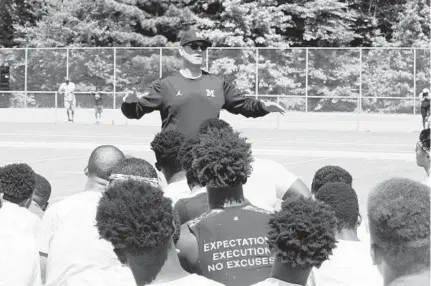  ?? BY ADAM ZIELONKA/BALTIMORE SUN MEDIA GROUP ?? Jim Harbaugh, head football coach at the University of Michigan, addresses attendees at Saturday’s exposure camp held at Bowie State.