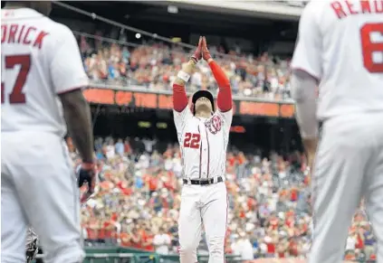  ?? NICK WASS/AP ?? Juan Soto of the Nationals celebrates his two-run home run in the seventh inning as Howie Kendrick (47) and Anthony Rendon watch Sunday.