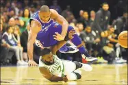  ?? Drew Hallowell / Getty Images ?? The Sixers’ Al Horford, top, falls over the Celtics’ Jaylen Brown during their game on Wednesday.