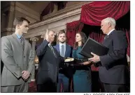  ??  ?? AP/J. SCOTT APPLEWHITE­Vice President Mike Pence (right) administer­s the Senate oath of office during a mock swearing-in ceremony Wednesday for Sen. Doug Jones, D-Ala. Jones was joined by his wife, Louise, and their two sons.