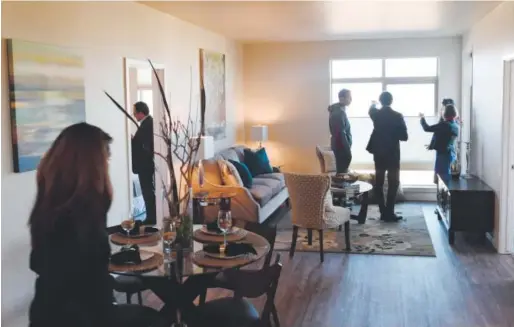  ?? RJ Sangosti, Denver Post file ?? People tour one of the 84 rental units at the Northfield at Stapleton Apartments, a relatively new housing developmen­t in the Stapleton area of Denver where each unit is energy efficient and designed to be affordable.