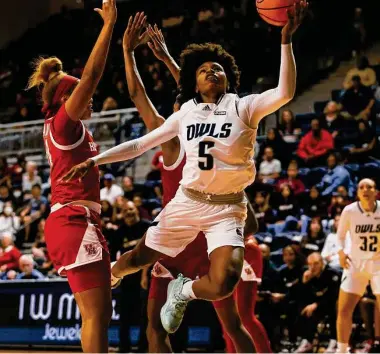  ?? Tim Warner/Contributo­r ?? Rice senior point guard Destiny Jackson goes up for a layup in front of UH defenders during Saturday’s game at Tudor Fieldhouse. Jackson finished with 33 points, seven rebounds, five assists and three steals.