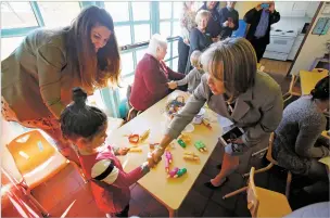  ??  ?? Gubernator­ial candidate Michelle Lujan Grisham shakes hands Monday with Luna Martinez, 3, during a visit to the Early Childhood Center of Excellence in Santa Fe.