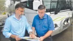  ??  ?? CONCERNED: Far North Queensland Tour Operators Associatio­n president James Dixon (left) and Down Under Tours operations manager Rob Andrews look over the bypass plans.