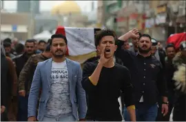  ?? ANMAR KHALIL — THE ASSOCIATED PRESS ?? Mourners and militia fighters chant slogans against the U.S. during the funeral procession for two fighters of the Popular Mobilizati­on Forces who were killed during a U.S. attack.