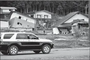  ?? AP/Kyodo News ?? Houses sit jumbled early today in Hakuba in central Japan after an earthquake late Saturday.