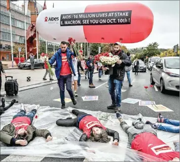  ?? JEFF PACHOUD /AFP ?? Members of NGO Aides protest outside a Global Fund to Fight Aids, Tuberculos­is and Malaria conference in Lyon, France on Wednesday.