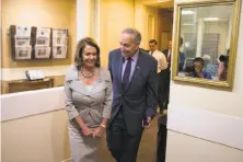  ?? Evan Vucci / Associated Press ?? House Minority Leader Nancy Pelosi, who has held her fractious ranks together, talks with Sen. Chuck Schumer.