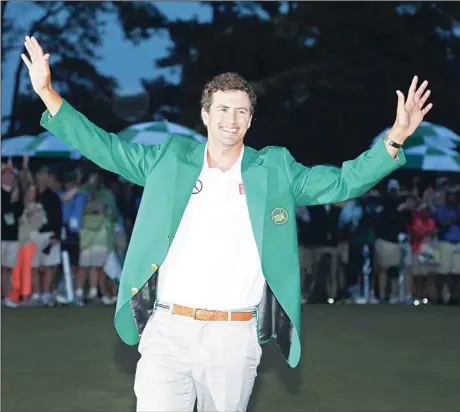  ??  ?? Adam Scott, of Australia, shows off his green jacket after winning the Masters golf tournament, April 14, in Augusta, Ga. (AP)