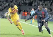  ?? AFP ?? Barcelona’s Lamine Yamal, left, and Paris Saint-Germain’s Nuno Mendes fight for the ball.