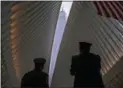  ?? CRAIG RUTTLE — THE ASSOCIATED PRESS ?? In New York: Two members of the New York City fire department look toward One World Trade Center.