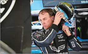  ?? JOHN AMIS/AP PHOTO ?? Pole winner Kevin Harvick takes off his helmet Saturday in the garage during practice for the NASCAR Monster Cup series race at Atlanta Motor Speedway in Hampton, Ga.