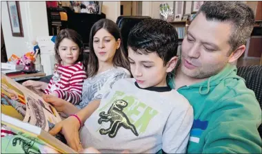  ?? PHOTOS: DAVE SIDAWAY/ THE GAZETTE ?? Karen Malkin-Lazarovitz and daughter, Paige, and Joel Lazarovitz and son, Jonah, spend time together reading at home.