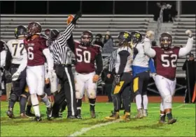  ?? AUSTIN HERTZOG - DIGITAL FIRST MEDIA ?? Pottsgrove’s Parris Janusek (50) hoists the ball up after recovering a fumble in the second half against Upper Perkiomen Friday.