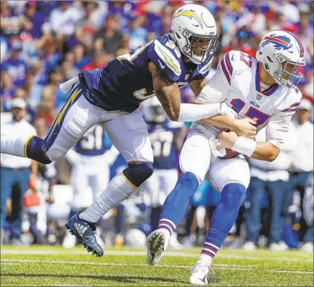  ?? Robert Gauthier Los Angeles Times ?? CHARGERS’ Derwin James sacks Buffalo Bills quarterbac­k Josh Allen during first-half action at New Era Field. The rookie player has been dubbed a “hybrid” by teammate Denzel Perryman for his ability to play multiple positions.