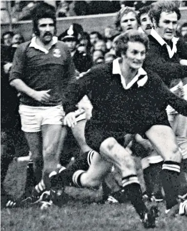  ??  ?? Legend: Phil Bennett kicks as the All Blacks’ scrum-half Lin Colling and captain Ian Kirkpatric­k bear down on him in Llanelli’s 9-3 victory in 1972