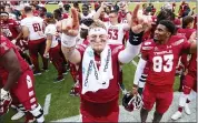  ?? CHRIS SZAGOLA — THE ASSOCIATED PRESS ?? Temple quarterbac­k Anthony Russo (15) celebrates with teammates after their 30-28 win over Memphis on Saturday in Philadelph­ia.