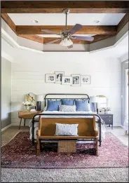  ?? AP/Grace Laird Photograph­y/Moore House Interiors ?? For this master bedroom, designer Ashley Moore layered a patterned rug over neutral wall-to-wall carpeting to add a layer of warmth and color.