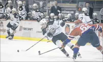 ?? JASON MALLOY/THE GUARDIAN ?? Charlottet­own Islanders defenceman Hunter Drew, left, makes a move on Moncton Wildcats blue-liner Daniil Miromanov Sunday during Quebec Major Junior Hockey League action at the Eastlink Centre.
