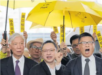  ?? Photo / AP ?? Occupy Central leaders (from left) Chu Yiu Ming, Benny Tai and Chan Kin Man join supporters before entering court in Hong Kong yesterday.