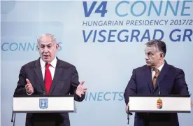  ??  ?? BUDAPEST: Hungarian Prime Minister Viktor Orban, right, listens to Israeli Prime Minister Benjamin Netanyahu during a press conference held in the Pesti Vigado building in Budapest, Hungary. —AP