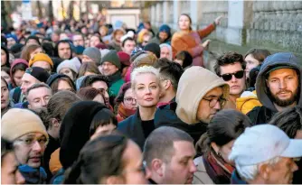  ?? AP-Yonhap ?? Yulia Navalnaya, center, widow of Alexey Navalny, stands in a queue with other voters at a polling station near the Russian Embassy in Berlin, after noon local time, Sunday.