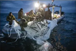  ?? U.S. NAVY VIA AP ?? Sailors assigned to Explosive Ordnance Disposal Group 2recover a high-altitude surveillan­ce balloon off the coast of Myrtle Beach, S.C., on Sunday.