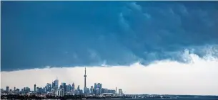  ?? MARK BLINCH THE CANADIAN PRESS FILE PHOTO ?? Like the rest of the world, Toronto faces more intense weather if it fails to address climate change, a new United Nations report by the Intergover­nmental Panel on Climate Change warns.