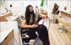  ??  ?? Above, Julie Jasaroska works with a customer at La Brosse Dry Bar in Cos Cob. Stephanie Leone-Kim, a former financier, has taken her entreprene­urial skills in a new direction by opening her own salon, La Brosse Dry Bar.
