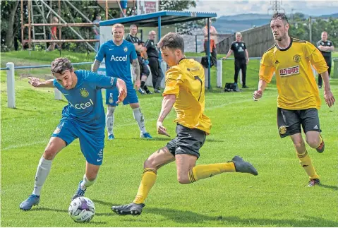  ??  ?? Lochee United (blue) cruised to a 7-0 victory in the Scottish Cup last week against Burntislan­d Shipyard.