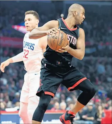  ?? Wally Skalij Los Angeles Times ?? CHRIS PAUL grabs a rebound from Blake Griffin and even exchanges words, bumps and nudges with his former teammate. Paul led the Rockets with 19 points while Griffin had 29 points before being ejected late.