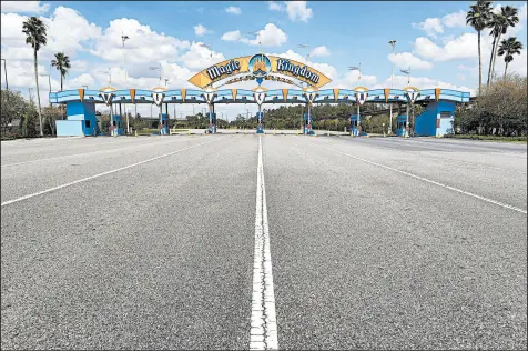  ?? JOE BURBANK/AP ?? Walt Disney World’s Magic Kingdom sits empty March 24. The Orlando theme park remains closed.