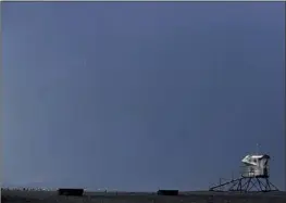  ?? Wally Skalij Los Angeles Times ?? A LIGHTNING BOLT strikes the ocean off Huntington Beach on Monday. It’s very unusual for the coast to see widespread lightning, a meteorolog­ist says.