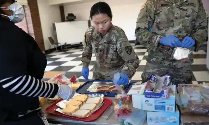  ??  ?? National guard troops put together sandwiches for coronaviru­s-affected residents in New Rochelle, New York. Photograph: John Moore/ Getty Images