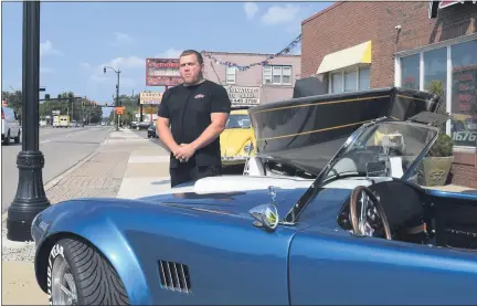  ?? PHOTOS BY MITCH HOTTS — THE MACOMB DAILY ?? Eric Lafata, vice chair of the Roseville DDA, stands next to a 1965AC Cobra that will be on display during Saturday’s Jammin’ at the Junction Car Show on Utica Road.