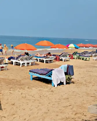  ??  ?? Tourists and locals at one of Goa’s beaches