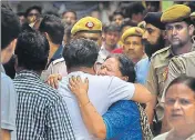  ?? PTI ?? Relatives mourn the death of 11 members of the Burari family who were found hanging from an iron grille in the roof.