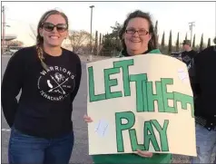  ??  ?? Parent Emily Van Andel, left, with parent supporter Katrina Sills, rally at Tehachapi High School’s Coy Burnett Stadium on Friday. They want sports to open up as do others who rallied under “Let Them Play.”
