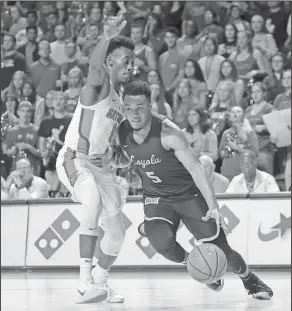  ?? Associated Press ?? Driving: Loyola-Chicago guard Marques Townes (5) drives past Florida guard Mike Okauru (0) during the first half of their game in Gainesvill­e, Fla., on Wednesday.