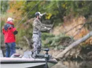  ?? STAFF PHOTO BY ERIN O. SMITH ?? Jason Risley and Logan Millsaps fish from their boat during Fishing League Worldwide Bass Fishing League Regional Championsh­ip tournament on Oct. 25.