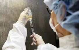  ?? TONY DEJAK / AP ?? Certified pharmacy technician Peggy Gillespie fills antibiotic­s into a syringe for use as an I.V. push at ProMedica Toledo (Ohio) Hospital. Antibiotic-resistant bacteria have evolved the ability to withstand drugs that ought to stop them.