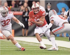  ?? MARK HOFFMAN / MILWAUKEE JOURNAL SENTINEL ?? Wisconsin running back Jonathan Taylor (23) was held to 41 yards rushing against Ohio State on Saturday.