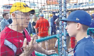  ?? MICHAEL COLEMAN/JOURNAL ?? Rep. Steve Pearce, R-N.M., gives Brayden Ford of Rio Rancho instructio­ns for his role as honorary batboy at Thursday night’s Congressio­nal Baseball Game.