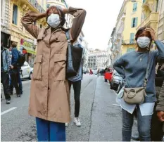  ?? Foto: Valery Hache, dpa ?? Nach einem Messerangr­iff in der Kirche Notre‰Dame in der Küstenstad­t Nizza steht eine Verwandte (links) eines Opfers weinend auf der Straße.