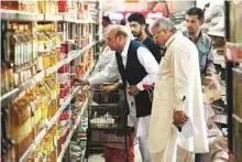  ?? AP ?? People browse specially -priced foods at a government­run supermarke­t, ahead of the beginning of Ramadan in Islamabad, yesterday.