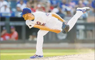  ?? Jim McIsaac / Getty Images ?? The Mets’ Zack Wheeler pitches in the sixth inning Saturday against the Nationals.