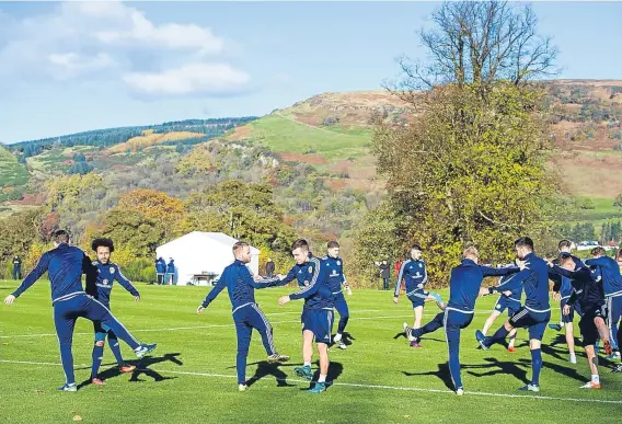  ??  ?? Scotland players get ready for Friday night’s World Cup qualifier at Wembley in their picturesqu­e Mar Hall training base.